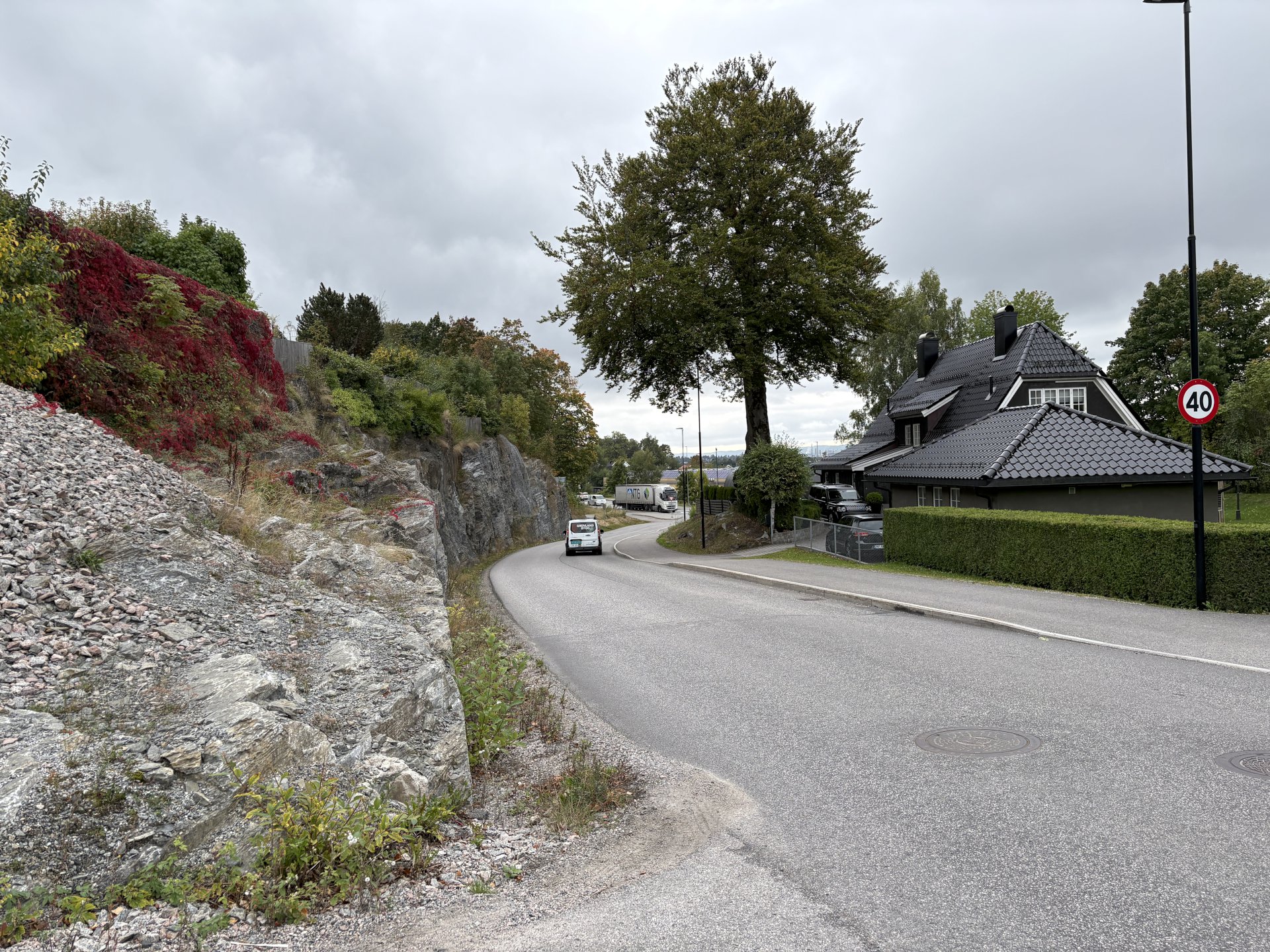 Gate med hus og natur på siden